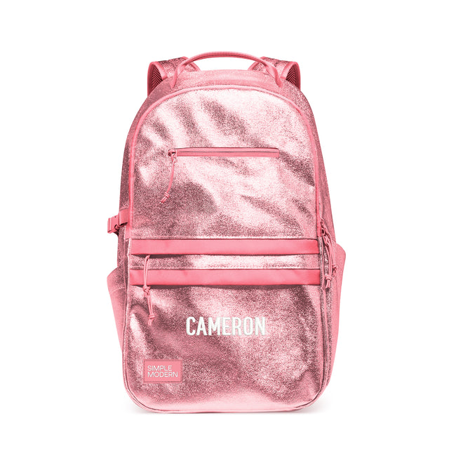 Rose pink metallic children's backpack with padded shoulder straps, carry handle, front zippered pockets, and side compression straps. Features 