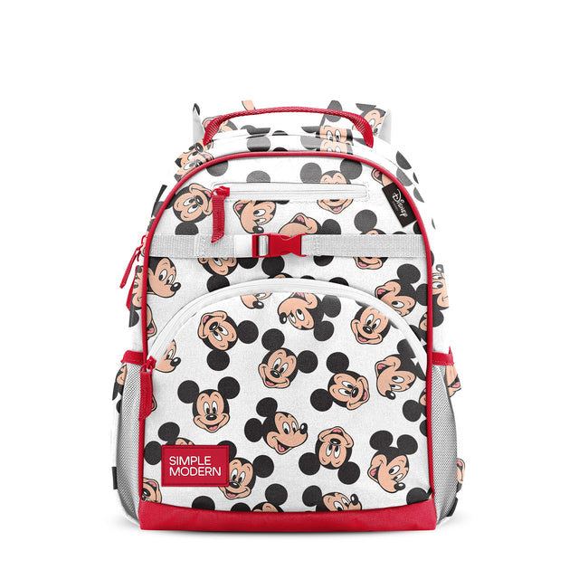 White children's backpack with Mickey Mouse print, red trim, handles, and zippered pockets. Features Mickey faces and ears throughout, padded straps, top carry handle, and gray mesh side pockets. Simple Modern branded.