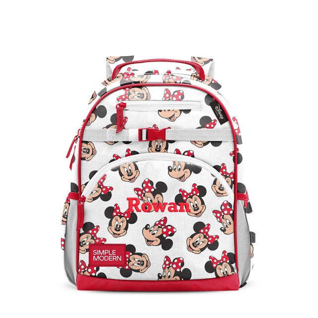 Red and cream children's backpack with Minnie Mouse character pattern, multiple zippered pockets, padded shoulder straps, top handle, side mesh pockets, and red chest strap buckle. Simple Modern brand label visible.