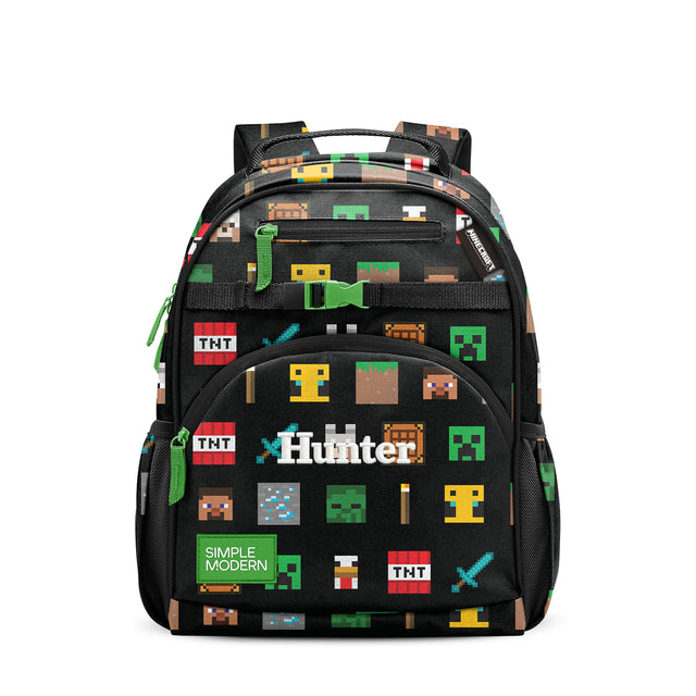 Black school backpack with pixelated yellow, red, white, and blue blocks, green straps and handles, front pockets labeled 