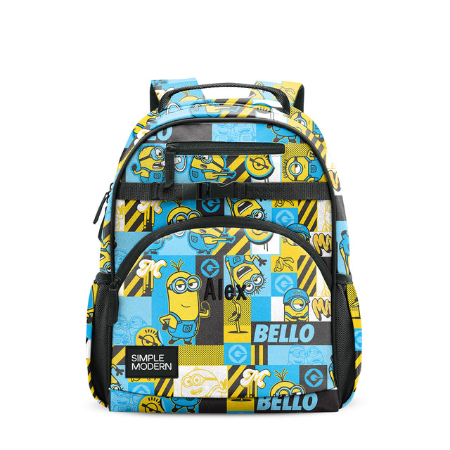 Minion-themed children's backpack with yellow, blue, white, and black patchwork design, black mesh pockets, padded straps, and top handle, shown front view on white background.