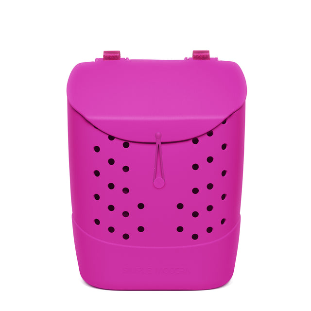 Magenta rounded backpack with black circular perforations, padded shoulder straps, and drawstring closure on white background.