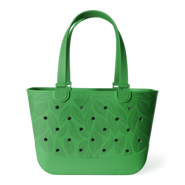 Green bucket tote bag with tropical leaf pattern and perforated details, featuring sturdy handles and 