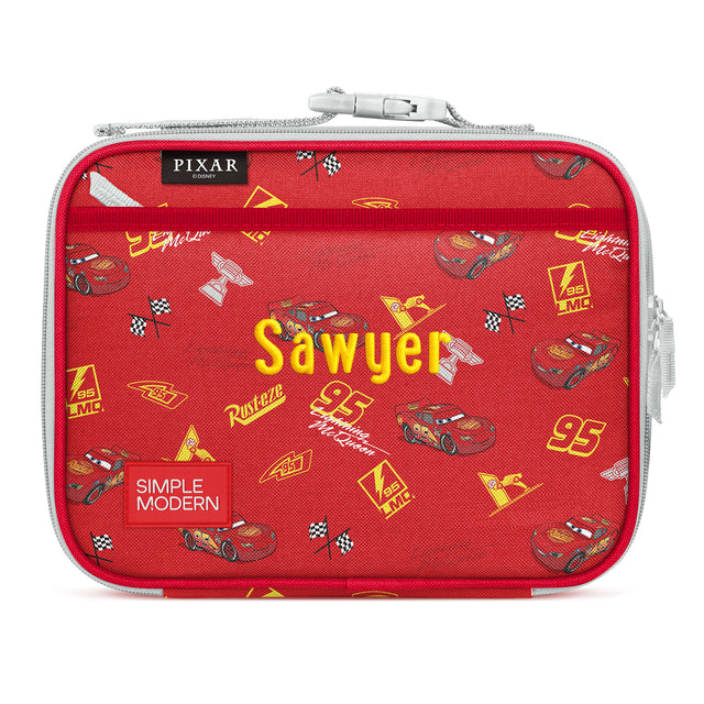 Red insulated lunchbox with Cars movie design featuring character Sawyer, checkered flags, race cars with number 95, mesh pockets, gray zipper, and yellow text on white background.