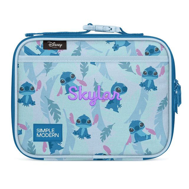 Light blue insulated lunch box featuring Disney's Stitch character in multiple poses with tropical leaf designs. Includes top zipper closure, front mesh pocket, dual carry handles, and magenta 
