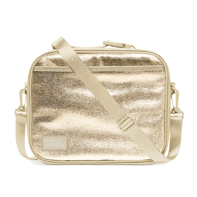 Champagne gold metallic quilted crossbody bag by Simple Modern with adjustable cream-beige shoulder strap, top handle, and gold hardware on white background.