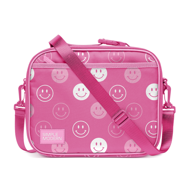 Hot pink smiley face crossbody bag with white and light pink smiling designs, featuring a ribbed textured hot pink shoulder strap.
