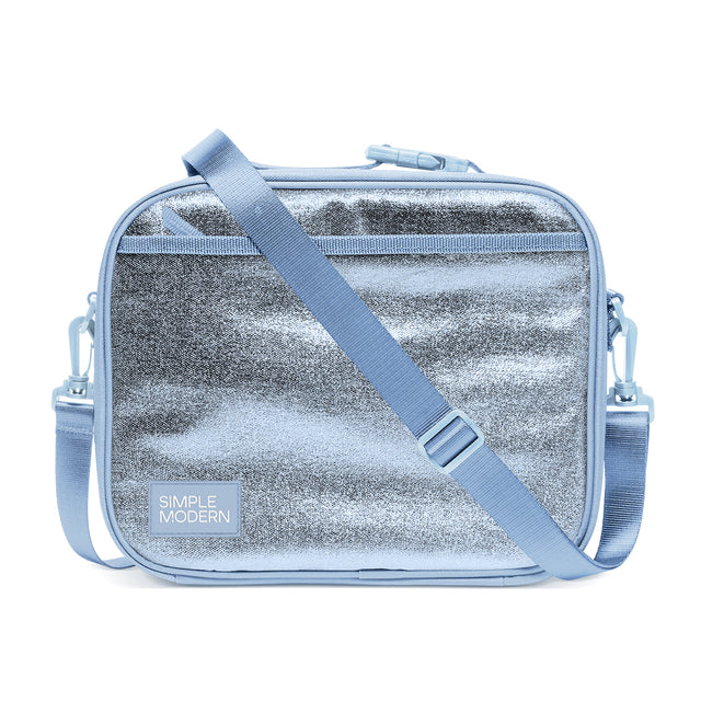 Periwinkle blue insulated lunch bag with silver metallic finish, geometric striping, blue crossbody strap, top zip closure, and 