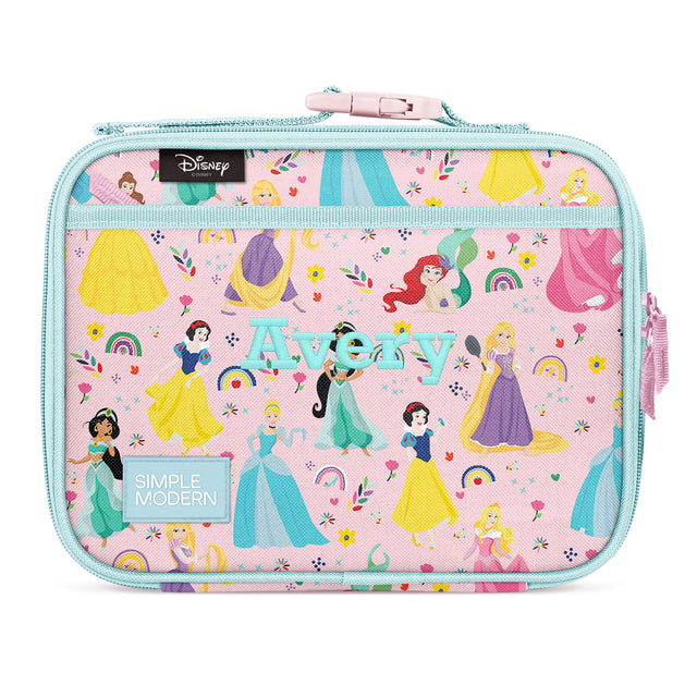 Pink insulated lunch box featuring Disney Princess characters in ball gowns with rainbow, flower, and star designs. Turquoise handles and zipper, shoulder strap attachment. Simple Modern brand.