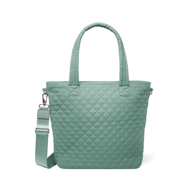 Sage green quilted tote bag with dual handles and detachable shoulder strap, front view