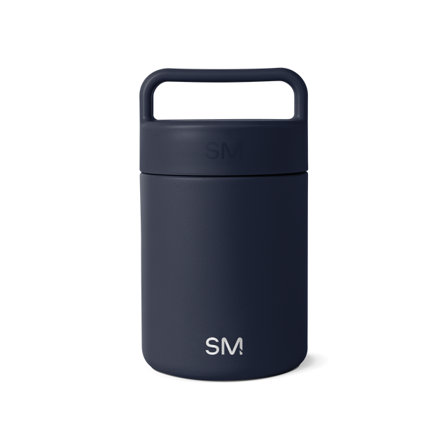 Navy blue glass jar with dark cap and handle on white background
