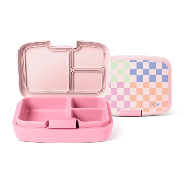 Pink bento lunch box by Simple Modern with divided compartments shown open next to matching lid featuring pastel checkerboard pattern in mint green, cream, periwinkle blue, lavender, and peach tones.