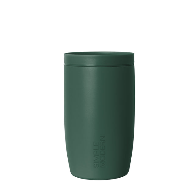 Muted sage green insulated tumbler with lid against neutral off-white background