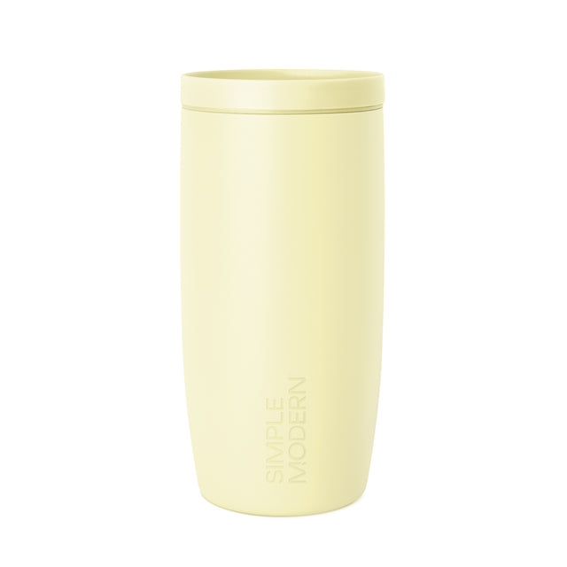 Soft pale yellow-cream colored tumbler with a white background