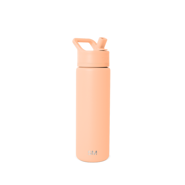 Tall cylindrical water bottle in soft peachy-beige with flip-top cap, angled straw opening, and curved carry handle
