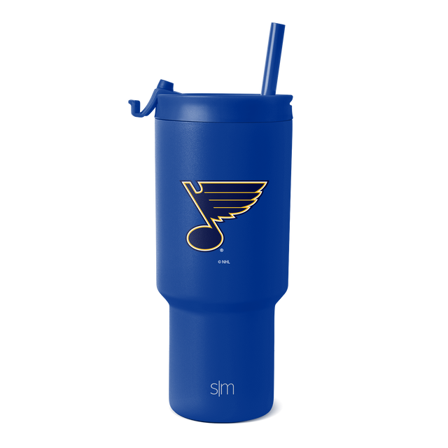 Bright royal blue tumbler with glossy finish, featuring St. Louis Blues team logo and SM branding in gold and cream.