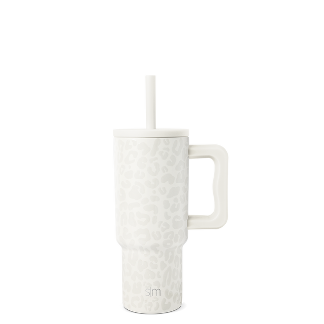 White tumbler with white straw on light gray background