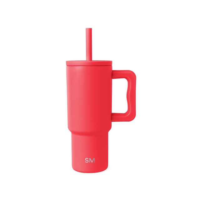 Coral-red insulated tumbler with handle and matching straw on white background. Features SM logo on front. Modern, cylindrical design with ergonomic grip. Product photography.