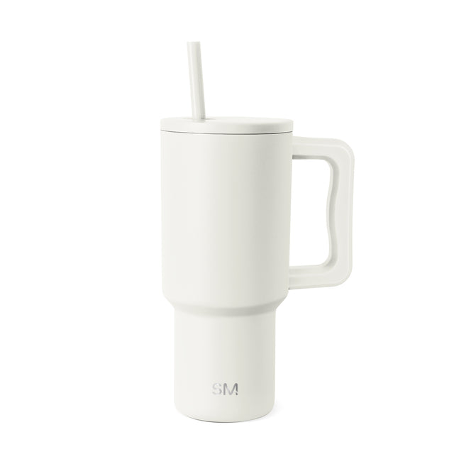 Cream-white insulated tumbler with handle, fitted lid, and straw on white background. Simple Modern logo visible on lower front. Matte finish stainless steel drinkware with modern tapered design.