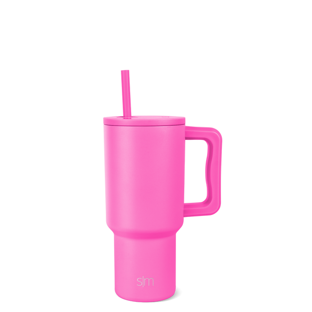 Hot pink tumbler with lid and straw on white background
