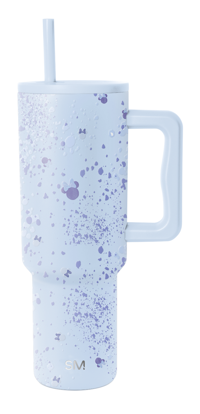 Soft lavender blue tumbler with scattered paint splatter and speckle details in darker shades across the surface.