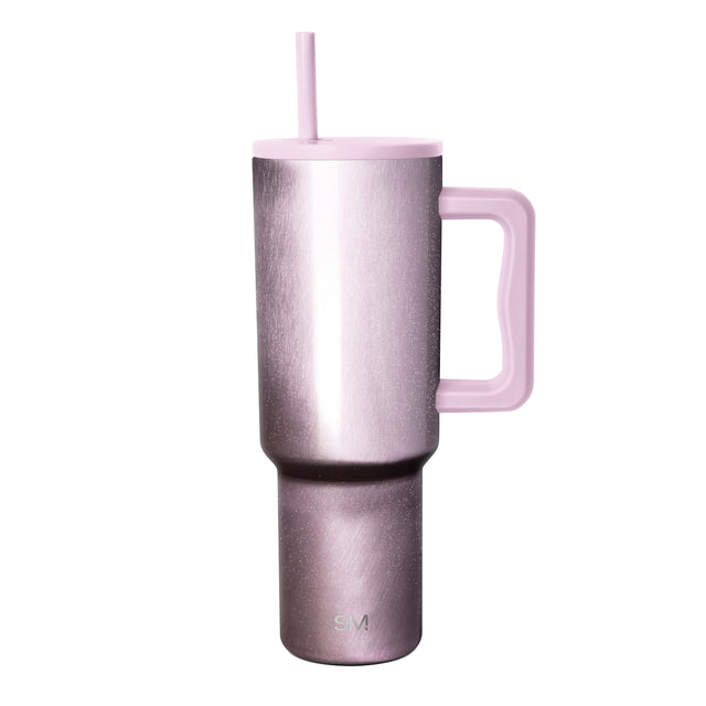 Metallic rose pink insulated tumbler with tapered cylindrical design, matching pink lid, handle, and straw, featuring Simple Modern logo on white background.