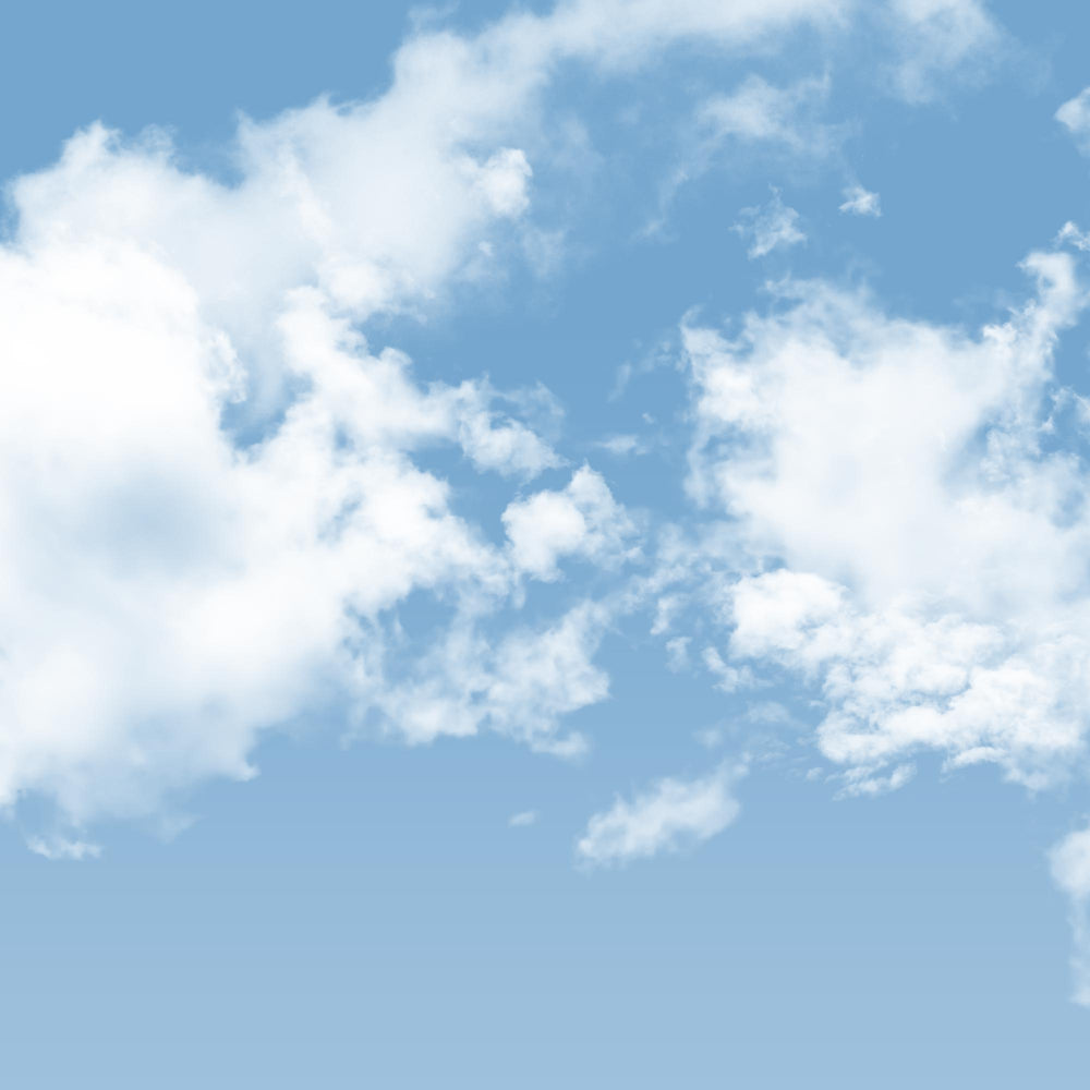 A light blue sky with scattered white, fluffy clouds.