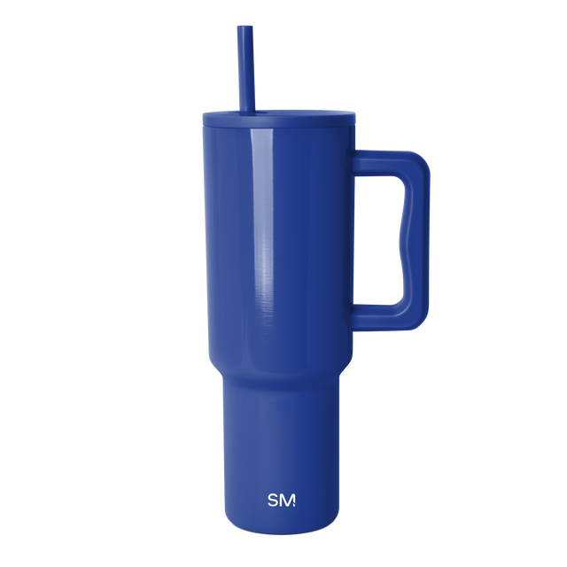 Tall cobalt blue insulated tumbler with cylindrical body and tapered base against white background
