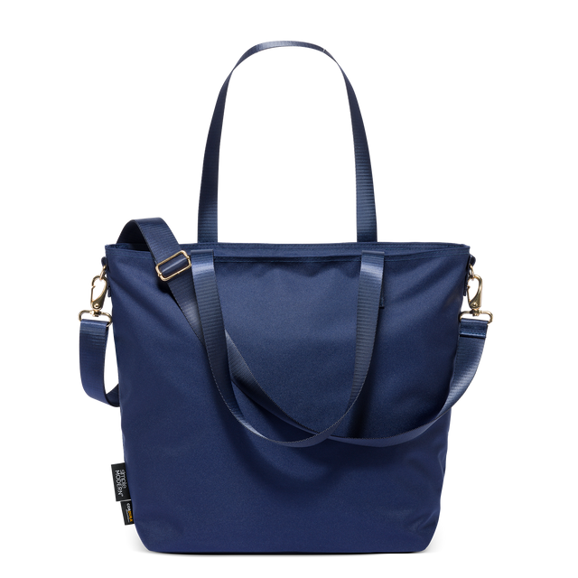 Harper Tote in deep navy blue Cordura fabric with gold-toned hardware, featuring dual handles and detachable crossbody strap, displayed on white background.