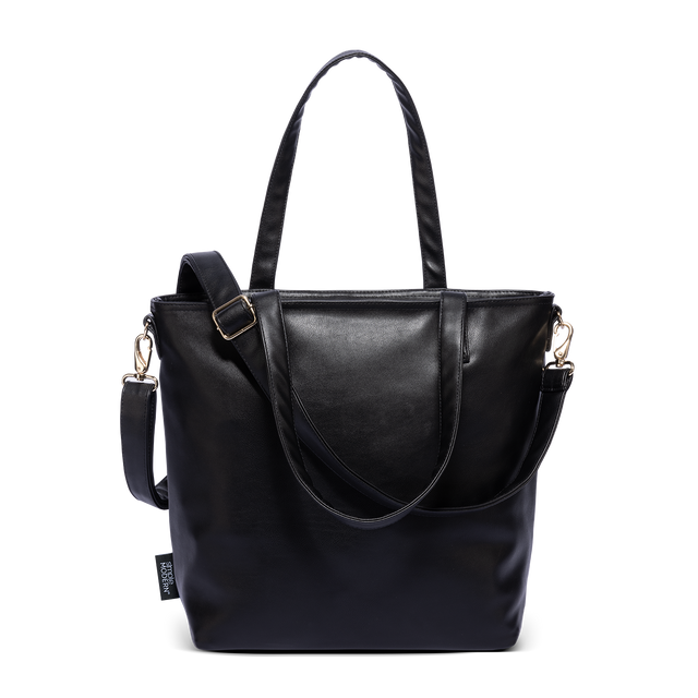 Black vegan leather Harper Tote with gold hardware, dual shoulder straps, and adjustable crossbody strap with buckle detail, shown against white background